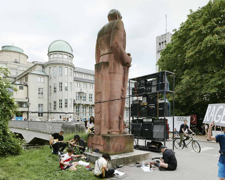 The young people playing music around the Bismarck monument. The German Museum can be seen in the background.
