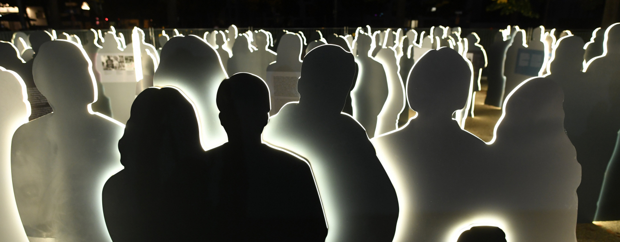 Night view of the large group of illuminated silhouettes