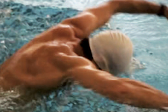 A swimmer doing freestyle in the Olympic swimming pool