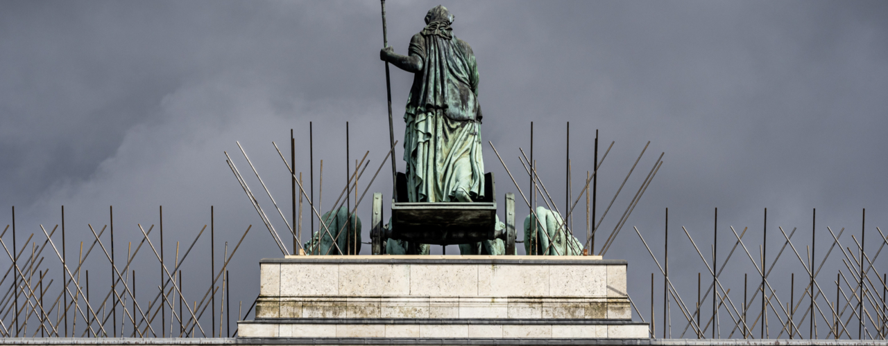 View of the uppermost part of the Siegestor with the Bavaria on her chariot, surrounded by the oversized doves Spikes, the whole against a thundery dark sky