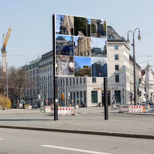 diagonal view of the billboard with the captcha motif by Milen Till. It shows, as usual with a captcha, nine square image tiles with motif cutouts from the surroundings of the billboard