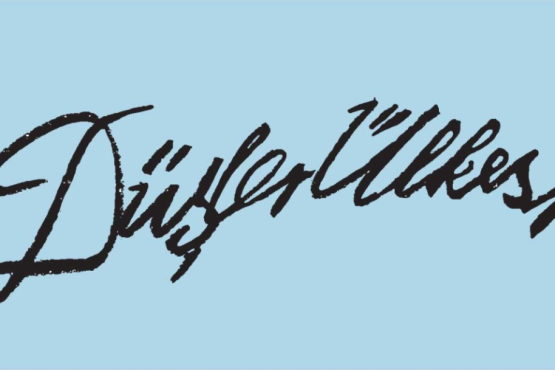 In black handwriting on a blue background appear the words "Düşler Ülkesi", which can be translated literally from Turkish as "Land of Dreams".