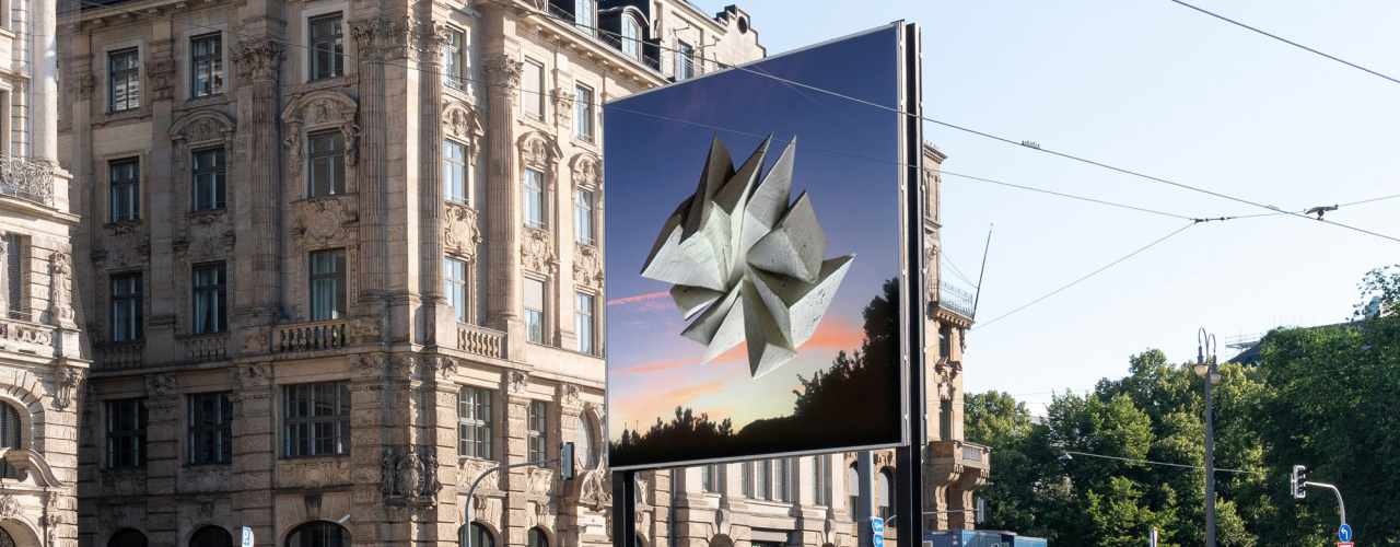 Diagonal view of the billboard side facing towards the city center. The motif shows an abstract stone formation floating above trees in front of a sunrise.