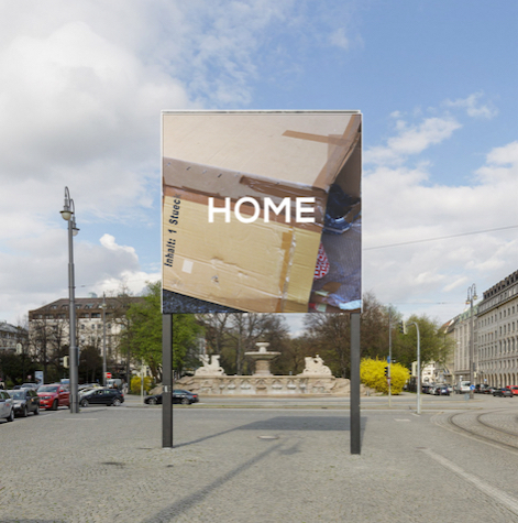 Frontal view of the billboard. The motif shows cardboard boxes glued together to form a temporary canopy.