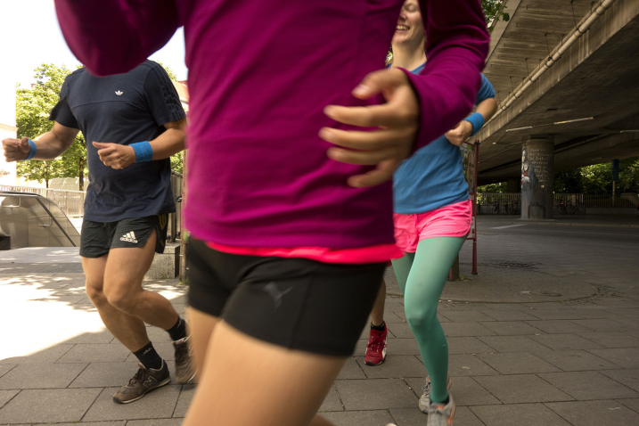 View of four joggers passing under Candidbrücke (Candid Bridge).