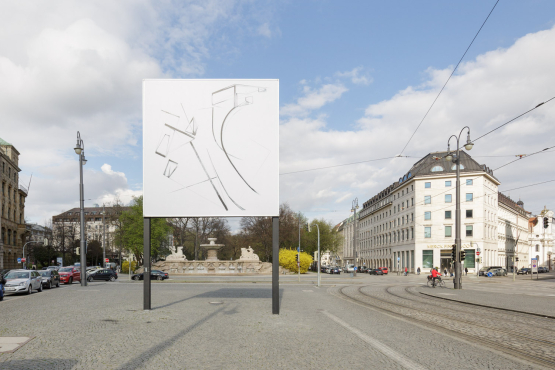 View of Lenbachplatz facing out of the city. The billboard in the centre shows an ink drawing in black and white with geometric and curved shapes and lines.