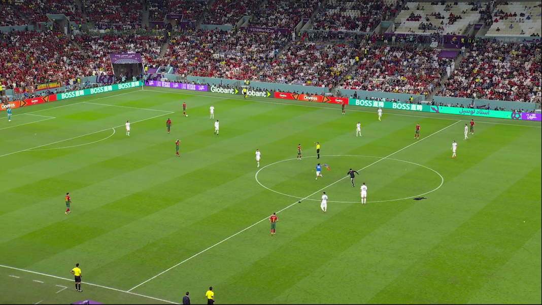 Blick auf ein Fussballspiel von schräg oben in einem gut besetzten Fussballstadion.